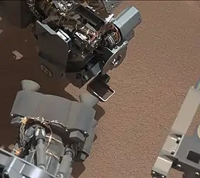 First use of the Curiosity rover scooper as it sifts a load of sand at "Rocknest" (October 7, 2012).