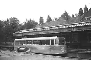 Bus-like vehicle parked at the platform of a railway station