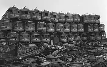 Former Pacific Electric Railway streetcars stacked at a junkyard awaiting destruction in the US, March 1956