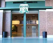 Photo showing an entrance surrounded by brick with the hall of fame logo above