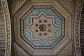 Sculpted and painted wooden ceiling in one of the rooms around the courtyard