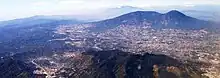 The massive San Salvador volcano dominates the landscape and skyline west of the city of San Salvador.