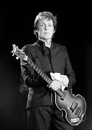 Paul McCartney with his Höfner bass in 2010. Notice that McCartney has removed the pearloid pickguard. He removed the pickguard during The Beatles' 1966 US tour.