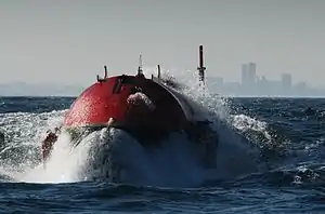 The front of the Pelamis machine bursting through a wave at the Aguçadoura Wave Park