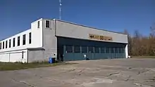 Airport hangar behind cracked pavement