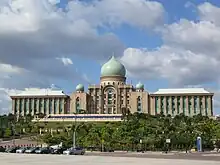 Large building with a series of flags in front of it