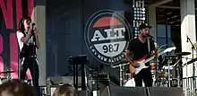 The band performing at an outdoor stage