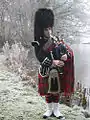 Piper playing the Great Highland Bagpipes in traditional Scottish piper's uniform (2010)