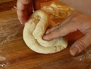 Pizza dough being kneaded before being left undisturbed and allowed time to proof