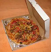 An open pizza box with a pizza inside