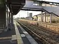 A view of the platforms and tracks. Note the covered footbrige.