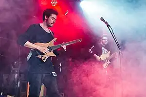 Plini playing guitar onstage