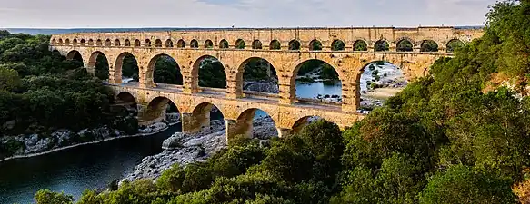 The multiple arches of the Pont du Gard in Roman Gaul (modern-day southern France). The upper tier encloses an aqueduct that carried water to Nimes in Roman times; its lower tier was expanded in the 1740s to carry a wide road across the river.