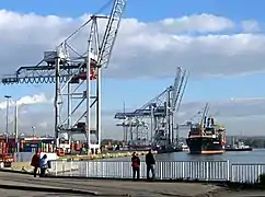 Cargo vessel using the appropriate facilities for container traffic (container cranes) at the port of Le Havre.