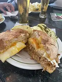 A bifana sandwich served in Porto with pulled pork, egg, and cheese