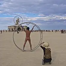 Image 30Naked participant at Burning Man 2016 posing as Leonardo da Vinci's Vitruvian Man (from Naturism)