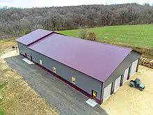 Image 11Post frame Barndominium with standing seam metal roof.  Large garage on the front side and living space on the back end. (from List of house types)