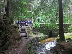 Steps down from the old main road to the foot of the trail