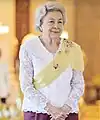 Queen Norodom Monineath wearing Av Pak and a yellow Sbai on top of it