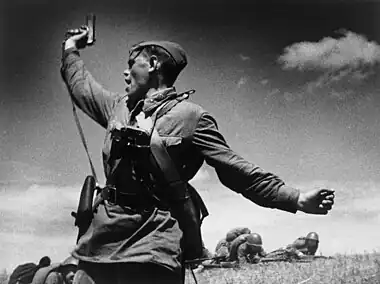 Image 9KombatPhotograph credit: Max AlpertKombat (Russian for 'battalion commander') is a black-and-white photograph by Soviet photographer Max Alpert. It depicts a Soviet military officer, armed with a TT pistol, raising his unit for an attack during World War II. This work is regarded as one of the most iconic Soviet World War II photographs, yet neither the date nor the subject is known with certainty. According to the most widely accepted version, it depicts junior politruk Aleksei Gordeyevich Yeryomenko, minutes before his death on 12 July 1942, in Voroshilovgrad Oblast, now part of Ukraine. The photograph is in the archives of RIA Novosti, a Russian state-owned news agency.More selected pictures