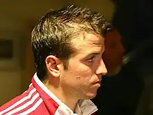 A man wearing a red and white jacket.