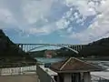 The bridge as viewed from Canada, with collapsed Schoellkopf Power Station visible in the distant