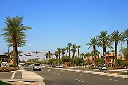 Palm trees line a busy four-lane street