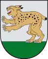 A coat of arms depicting a golden lynx with black spots, a red tongue, white teeth, and white claws standing on its back paws on green turf