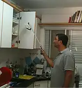 Retrieving a cup from a high shelf