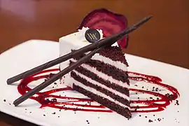 Red velvet cake is traditionally prepared as a layer cake topped with cream cheese or cooked ermine icing. The reddish color is achieved by adding beetroot or red food coloring.