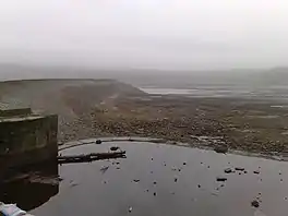 Image of an almost dry reservoir in heavy mist