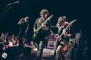 Performing in 2014 at the Skyway Theatre in Minneapolis. Depicted from to right: Jake Wolf, Charles Caswell, Francis Xayana, Patrick Somoulay, and Cam Murray (obscured by monitors).