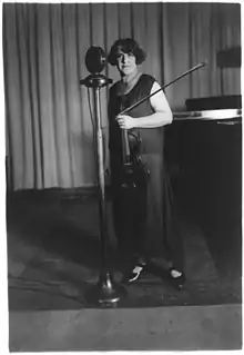 Renée Chemet standing at a microphone, from the George Grantham Bain Collection, Library of Congress.