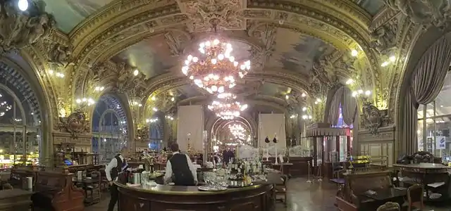 Train Bleu Restaurant in the Gare de Lyon (1902).  It looked out from the station facade on one side, and onto the train platform on the other.