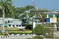 Retired RBAirF / TUDB Bell UH-1 (Bell 212, c/n: 30057, reg.: AMDB 100) helicopter gate guardian displayed inside the main gate of the airbase, September 2023.