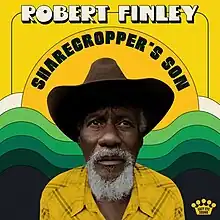 A photo of Finley in a ten-gallon hat on a yellow background