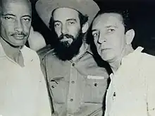 Camilo Cienfuegos wearing his stetson hat and beard, standing with Robert Paneque and Ronaldo Abello