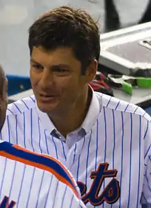 Robin Ventura, wearing a blue pinstripe jersey with the words METS partially cut off, converses with a fellow player