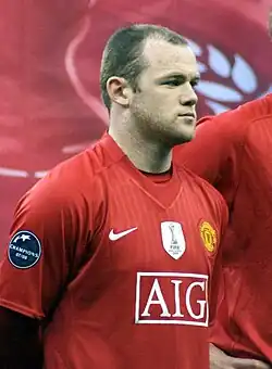 A man named Wayne Rooney lining up wearing Manchester United's jersey; the FIFA Club World Cup badge is clearly visible on the jersey.