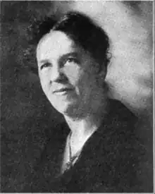 A black-and-white portrait of a white woman with dark hair