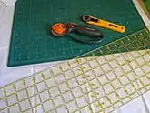  Rotary cutter on a mat being used for sewing and cutting purposes