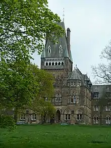 Part of a three-storey building with a tower surmounted by a Mansard roof