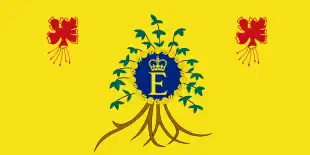 A yellow flag with flowers in both upper corners and a royal monogram logo in the center, surrounded by a plant.