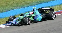 The 2007 Honda RA107 in its distinctive Earth livery, being driven by Rubens Barrichello at Malaysia in 2007.