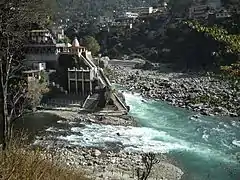 Confluence of Alaknanda (background) and Mandakini (foreground) at Rudraprayag.  In the 2013 Uttarakhand floods, after the Mandakini ravaged its banks, all the structures below the Chamundi temple have been seriously damaged and the large boulder called Narad Shila has disappeared while a long line of stones have appeared along the confluence.