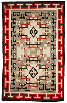 A wool rug ca.1900-1920 from the Navajo people in the Early Crystal style, with key patterns forming the outer border.