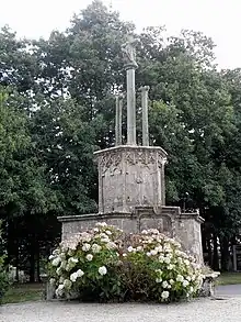 Photograph of a granite building crowned by a calvary