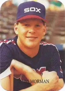 A man in a navy baseball jersey and cap