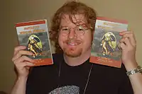 Russell B. Farr at SwanCon 2007 holding two copies of the anthology Fantastic Wonder Stories.