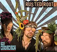 A photo of the band members wearing sunglasses and elaborate headdresses with foliage